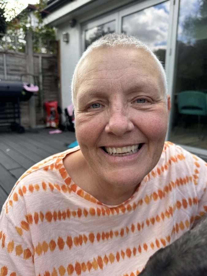 Michelle Norton smiling in a garden on a house sit